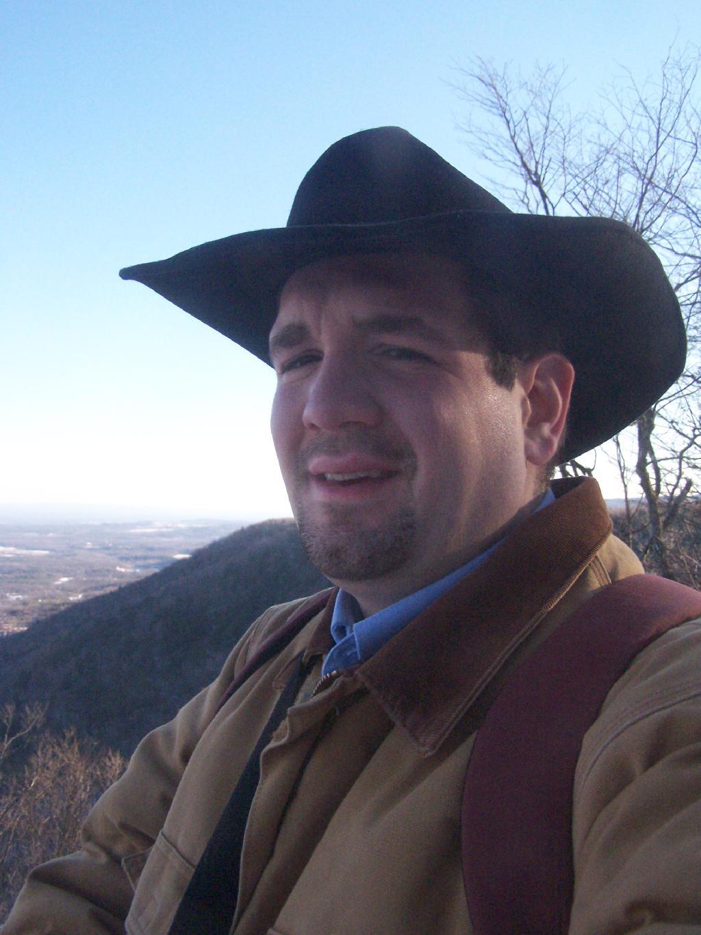 Photo: Looking Off Cliff With Beat Up Old Hat