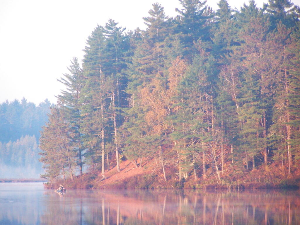 Photo: Small Game Hunter Paddling in Canoe on Jones Pond