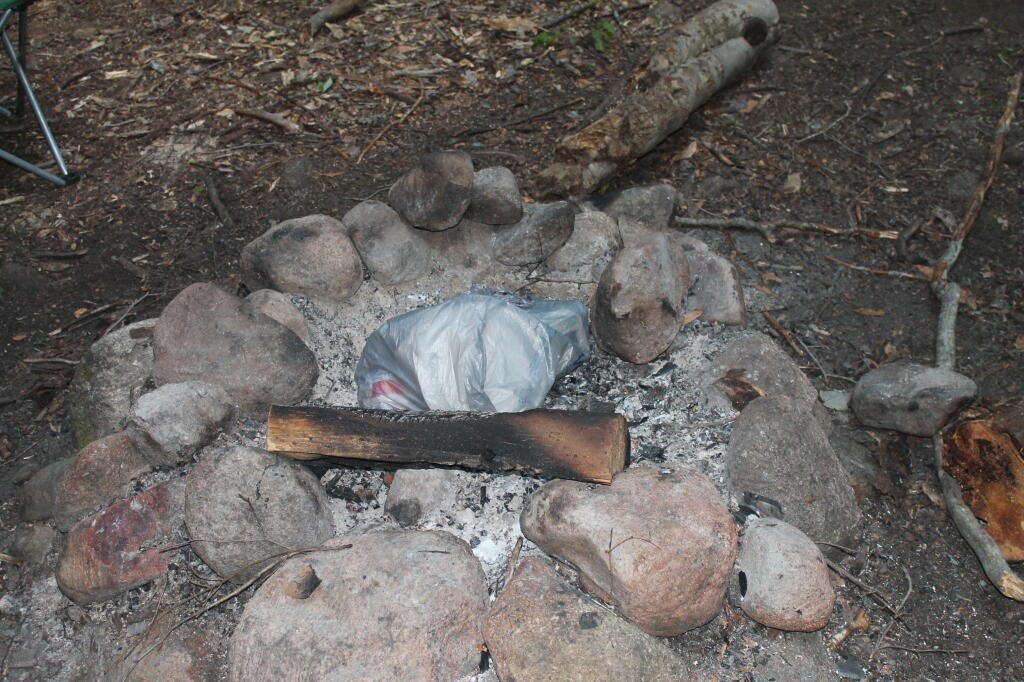 Photo: Day's Trash Waiting for the Campfire to Eat It