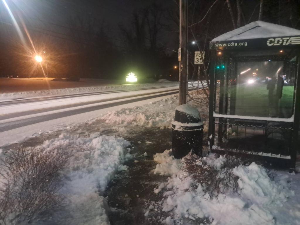 Photo: Cleaning out the bus stop before it freezes hard!