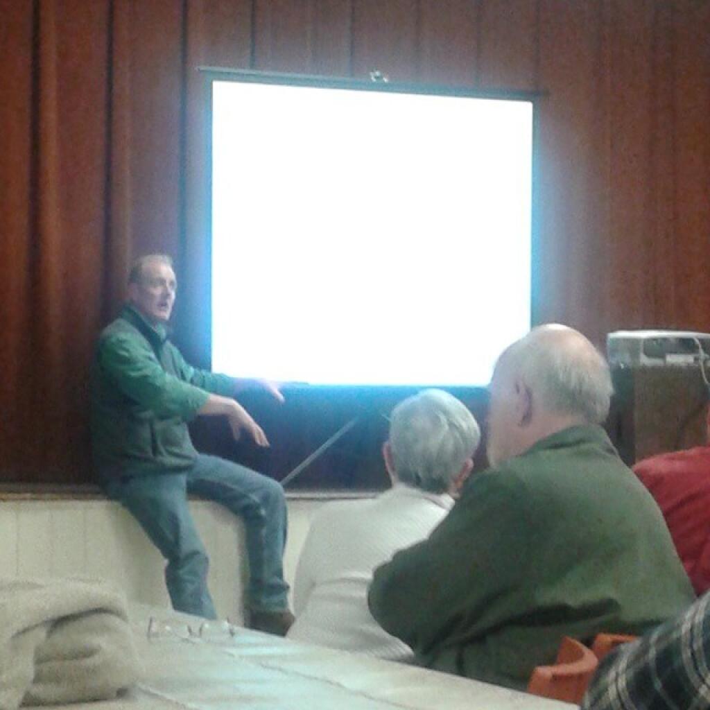 Photo: Neil Gifford next to PowerPoint at Save the Pine Bush Dinner